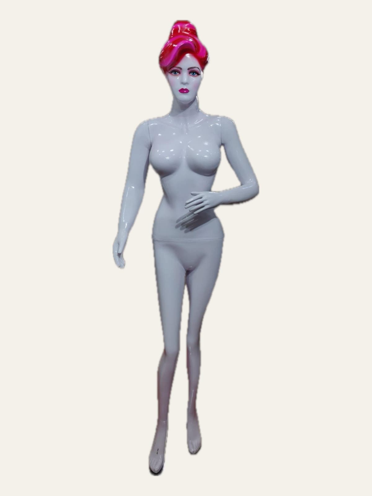 Female mannequin with painted makeup and a pink moulded hairstyle